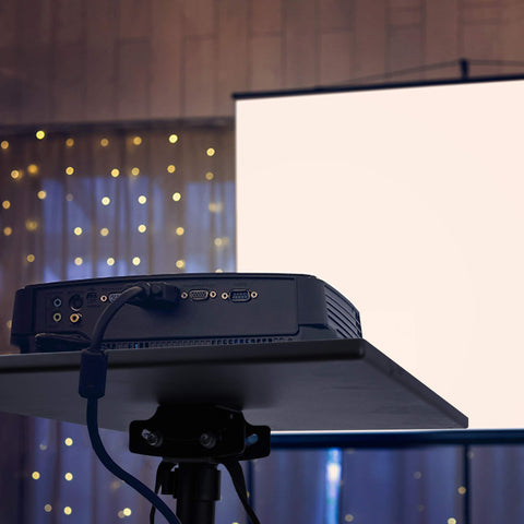 Duronic Projector Stand displaying a bright white screen during an indoor event.