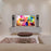 Duronic SPS1022-40 Speaker Stand featuring a flat-screen TV on a floating white console, flanked by two black bookshelf speakers on tall Duronic floor stands.