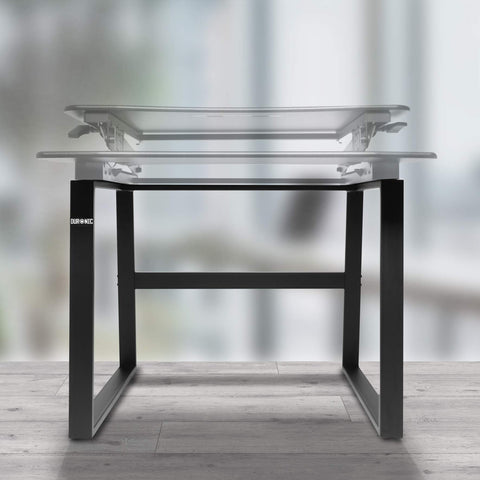 Duronic Sit-Stand Desk Frame featuring black metal legs on a wooden floor.