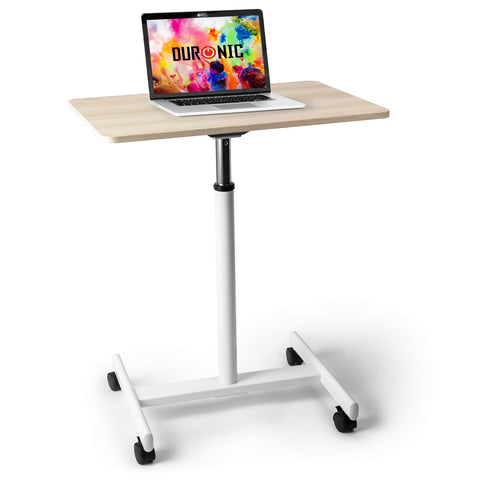 Duronic Sit-Stand Desk WPS67 featuring a light wood finish tabletop, white frame, and four lockable caster wheels, shown with a laptop on top.