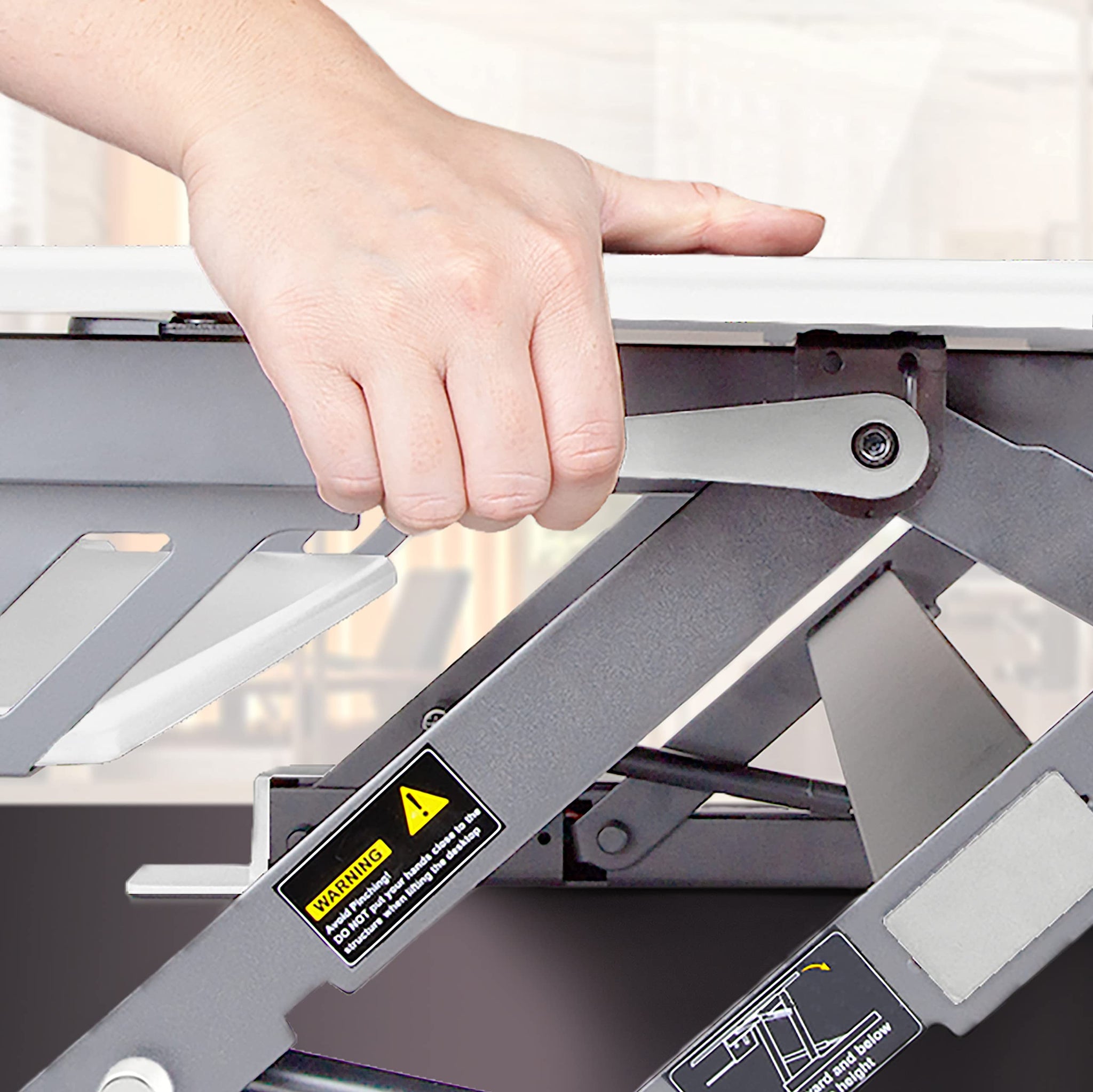 Duronic Sit-Stand Desk converter using the squeeze lever.