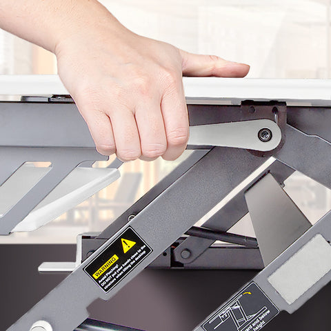 Duronic Sit-Stand Desk converter using the squeeze lever.