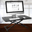 Duronic Sit-Stand Desk holding a desktop computer, keyboard, and mouse in an office.