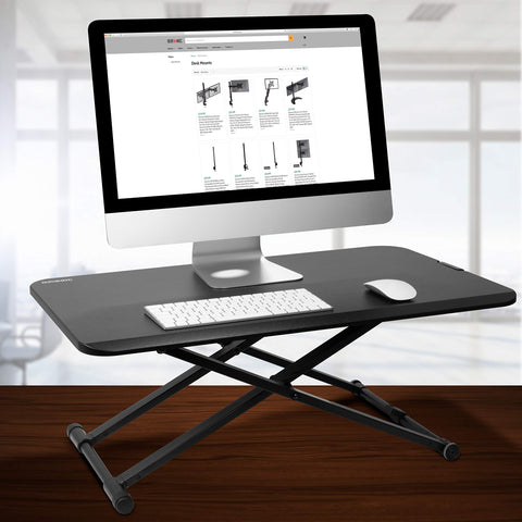 Duronic Sit-Stand Desk holding a desktop computer, keyboard, and mouse in an office.