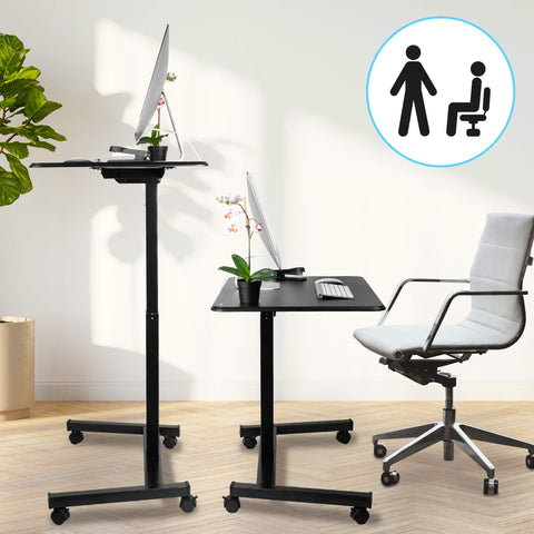 Duronic Sit-Stand Desk shown in both sitting and standing positions with a grey chair.