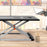 Duronic Sit-Stand Desk sleek black and silver adjustable standing desk converter sits on a wooden tabletop in a bright office setting