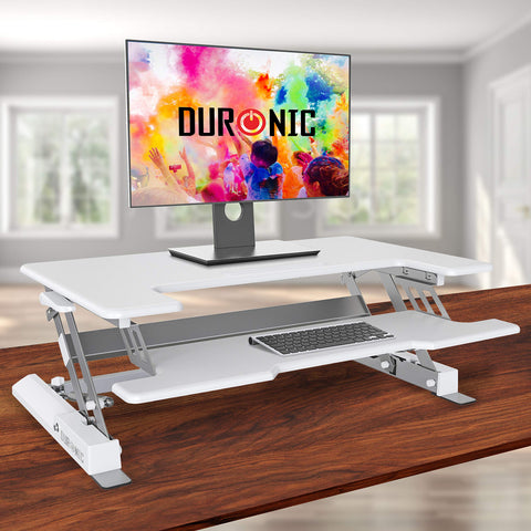 Duronic Sit-Stand Desk with a monitor and keyboard on a wooden table.
