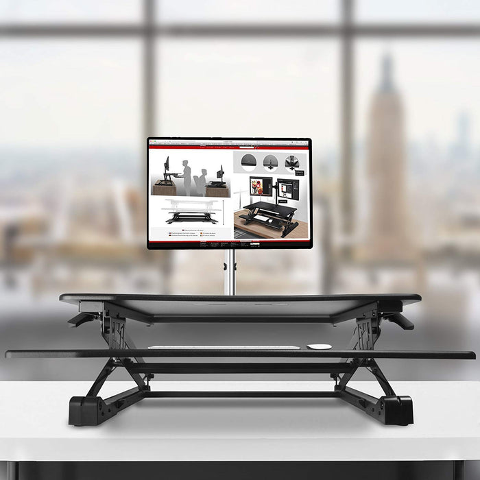 Duronic Sit-Stand Desk with a monitor mount, holding a screen on a table.