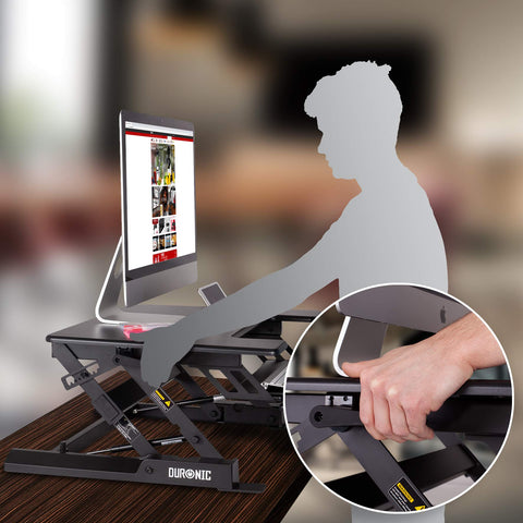 Duronic Sit-Stand Desk with a monitor on a wooden table.