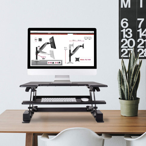 Duronic Sit-Stand Desk with an iMac, keyboard, and mouse on a wooden office desk.