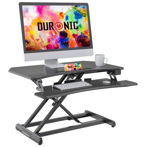Duronic Sit-Stand Desk with dual tiers holding a monitor, keyboard, and phone.