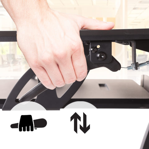 Duronic Sit-Stand Desk with hand squeezing a black lever to adjust the height