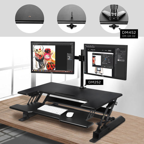 Duronic Sit-Stand Desk with keyboard tray, featuring dual monitors mounted via grommet hole..