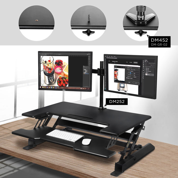 Duronic Sit-Stand Desk with keyboard tray, featuring dual monitors mounted via grommet hole..