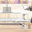 Duronic Sit-Stand Desk with keyboard tray, laptop, and tablet holder on wooden desk.