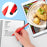 Duronic Stylus Pens writing a chicken recipe in a notebook next to a digital tablet.