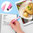 Duronic Stylus Pens writing in a notebook next to a digital tablet recipe.