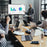 Duronic TV Stand Shelf holding a monitor during a business presentation in an office..