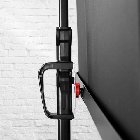 Duronic Tripod Projector Screen featuring adjustable handle lock set against white brick wall background.