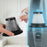 Duronic Vacuum Cleaner HEPA Filter showing a dirty HEPA filter being cleaned with a small white brush tool.