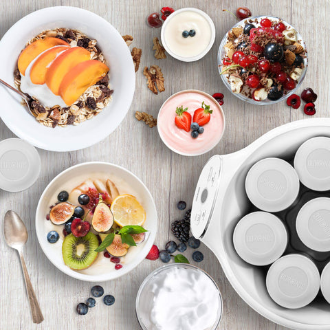 Duronic Yoghurt Makers surrounded by healthy breakfast bowls of fruit, granola, berries, and fresh yogurt.