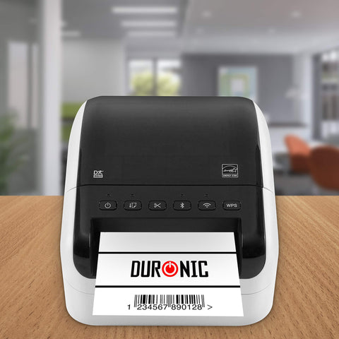 Duronic desktop thermal label printer printing a white barcode label on a wooden office desk.